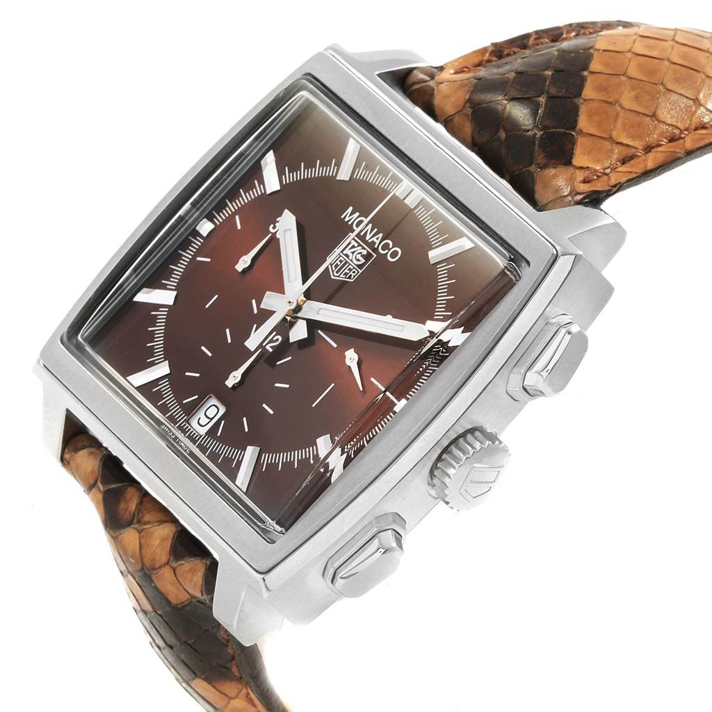 The image shows a Tag Heuer Monaco CW2114 Men's Stainless Steel Brown Dial CW2114 Men's Stainless Steel Brown Dial watch at a three-quarter angle, highlighting its dial, crown, push buttons, and the textured strap.