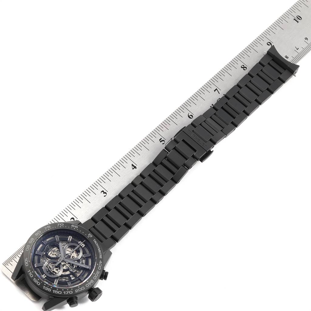 The image shows a Tag Heuer Carrera CAR2A91.BH0742 Men's Stainless Steel Black Dial CAR2A91.BH0742 Men's Stainless Steel Black Dial watch laid flat beside a ruler, showcasing the face and entire wristband.