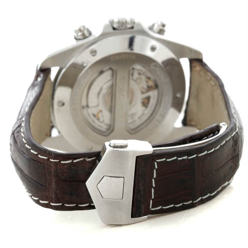 The Tag Heuer Carrera CAV511A.FC6225 Men's Stainless Steel Black Dial CAV511A.FC6225 Men's Stainless Steel Black Dial watch is shown from the back, displaying the open case back and leather strap with a deployant clasp.