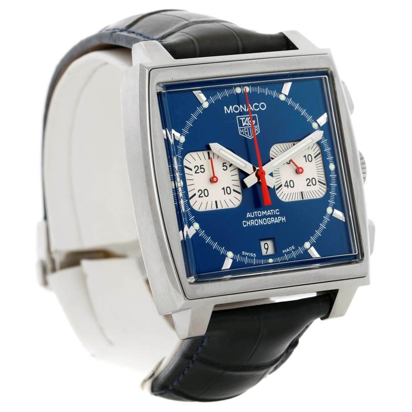 The image shows a three-quarter view of the Tag Heuer Monaco CW2113 Men's Stainless Steel Blue Dial CW2113 Men's Stainless Steel Blue Dial watch, displaying its blue dial, square case, subdials, and black strap.