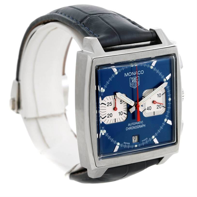 The image shows a side angle of the Tag Heuer Monaco CW2113 Men's Stainless Steel Blue Dial CW2113 Men's Stainless Steel Blue Dial watch, featuring its square face, blue dial, and black leather strap.