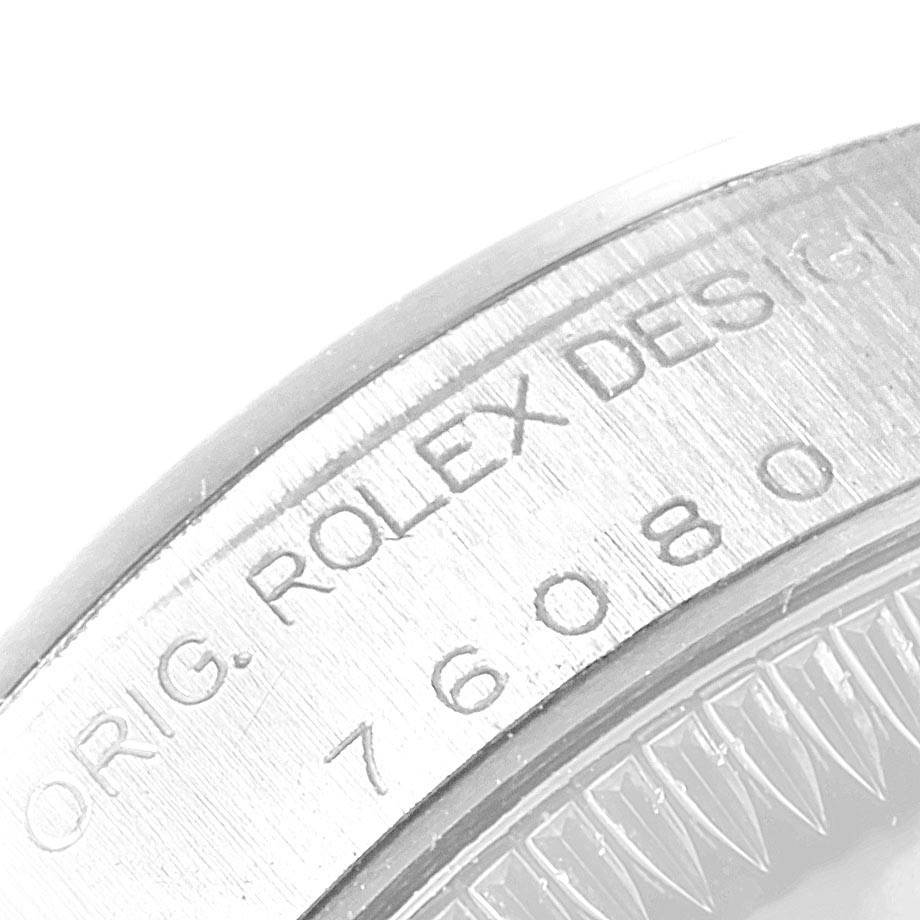 The image shows a close-up of the engraved bezel of a Rolex Oyster Perpetual 76080 Women's Stainless Steel Black Dial 76080 Women's Stainless Steel Black Dial watch.