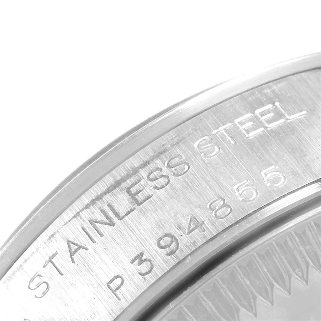 This close-up image shows the stainless steel case back of a Rolex Oyster Perpetual 76080 Women's Stainless Steel Black Dial 76080 Women's Stainless Steel Black Dial watch with engraved serial numbers.