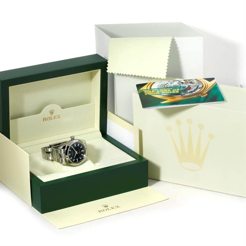 The image shows a Rolex Milgauss 116400 Men's Stainless Steel Black Dial 116400 Men's Stainless Steel Black Dial watch placed in its open box, alongside accompanying documentation.