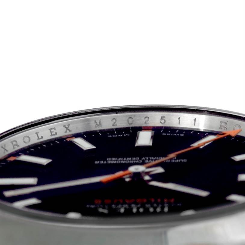 The image shows a close-up, side angle of the Rolex Milgauss 116400 Men's Stainless Steel Black Dial 116400 Men's Stainless Steel Black Dial' dial and inner bezel with part of the second hand.