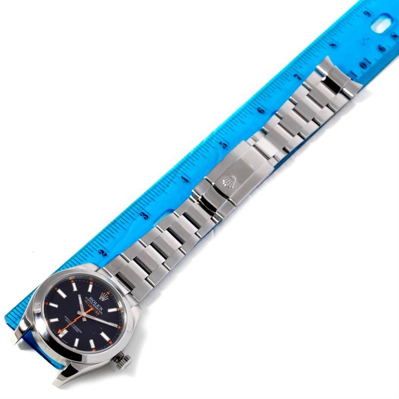 The image shows the face and bracelet of a Rolex Milgauss 116400 Men's Stainless Steel Black Dial 116400 Men's Stainless Steel Black Dial watch, laid flat next to a ruler for scale.