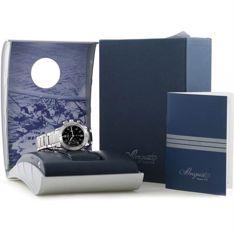 The image shows a Breguet Type XX - XXI - XXII 3820ST/H2/SW9 Men's Stainless Steel Black Dial 3820ST/H2/SW9 Men's Stainless Steel Black Dial model watch on a stand, with its box and accompanying booklets.