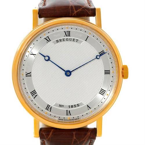 The image shows a front view of a Breguet Classique 5157 Men's Yellow Gold Silver Dial 5157 Men's Yellow Gold Silver Dial model watch, showcasing its dial, Roman numerals, blued hands, and leather strap.