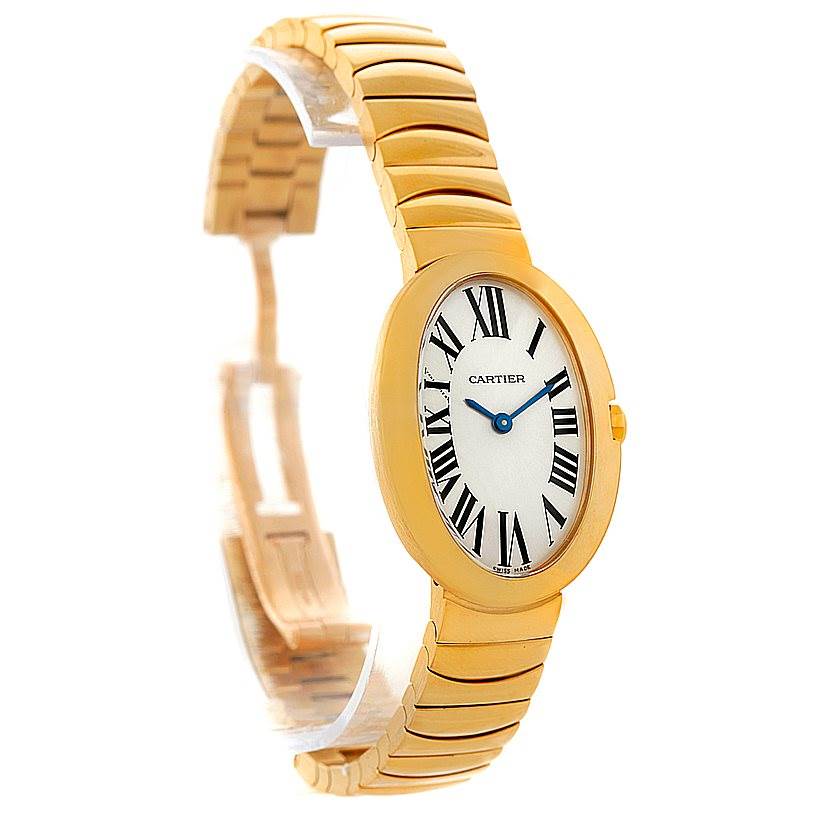 This image shows a Cartier Baignoire W8000008 Women's Yellow Gold Silver Dial W8000008 Women's Yellow Gold Silver Dial watch from a front-side angle, highlighting its oval dial, Roman numerals, and gold bracelet.