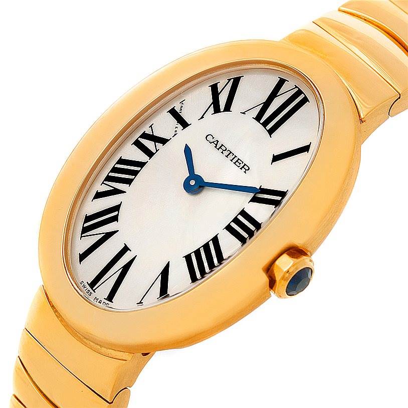 The image shows the Cartier Baignoire W8000008 Women's Yellow Gold Silver Dial W8000008 Women's Yellow Gold Silver Dial watch at a close-up angle, highlighting its face, Roman numerals, and part of its gold strap and case.