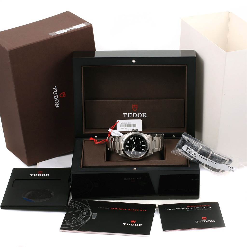 The image shows a Tudor Heritage Black Bay 79540 Men's Stainless Steel Black Dial 79540 Men's Stainless Steel Black Dial watch in its box with all accessories, manuals, and additional bracelet links.