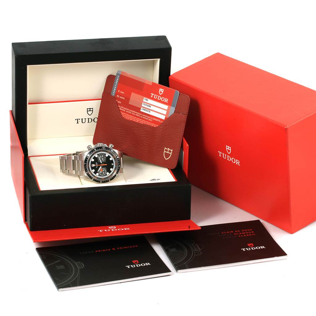 The image shows a Tudor Heritage Chrono 70330N Men's Stainless Steel Grey Dial 70330N Men's Stainless Steel Grey Dial watch in its open box, with warranty cards, booklets, and packaging visible.