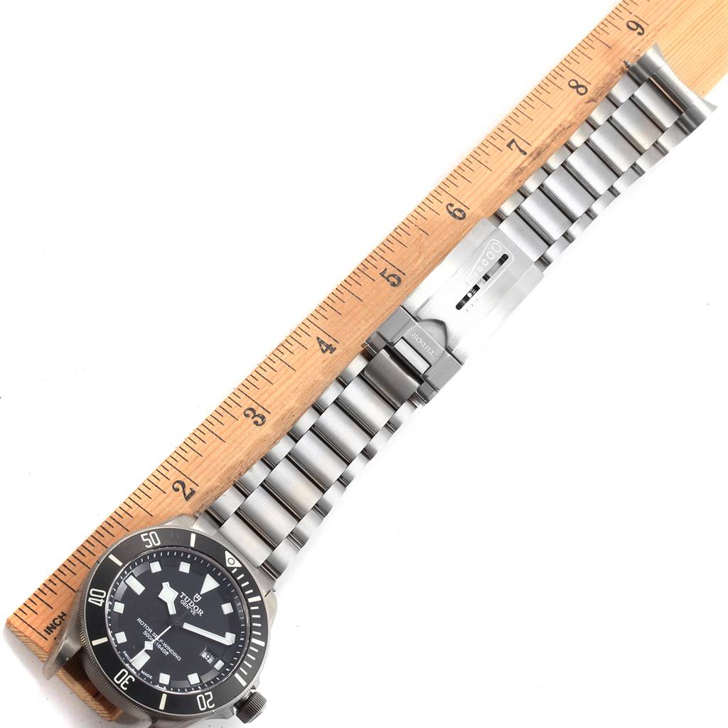 The image shows a Tudor Pelagos 25500TN Men's Titanium Black Dial 25500TN Men's Titanium Black Dial watch at an angle with its full bracelet and clasp extended alongside a ruler for measurement.