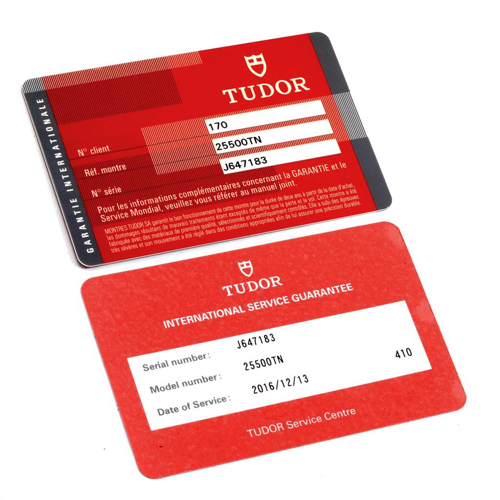 The image shows two red Tudor International Guarantee and Service Guarantee cards for the Tudor Pelagos 25500TN Men's Titanium Black Dial 25500TN Men's Titanium Black Dial model.