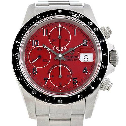 The image shows a frontal view of the Tudor Prince model watch, highlighting its red dial, three sub-dials, and date window.