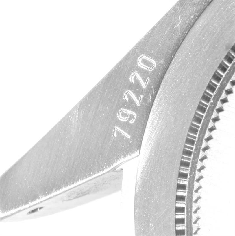 The image shows a close-up of the case lug and part of the bezel of a Tudor Heritage Black Bay 79220 Men's Stainless Steel Black Dial 79220 Men's Stainless Steel Black Dial watch, with the model number engraved.