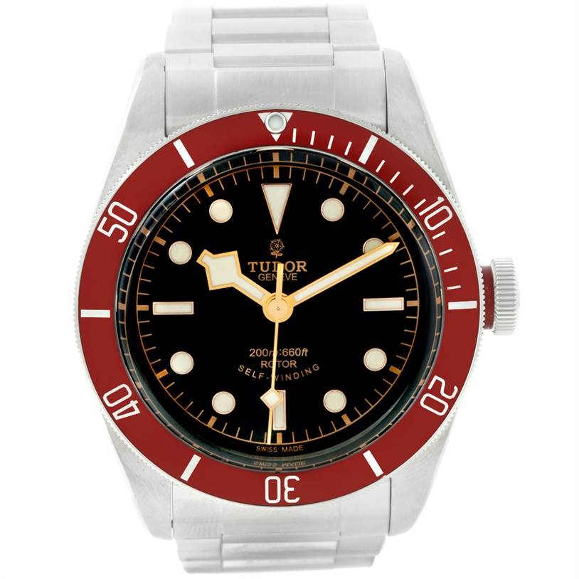 The image shows a front view of a Tudor Heritage Black Bay 79220 Men's Stainless Steel Black Dial 79220 Men's Stainless Steel Black Dial watch with a red bezel and stainless steel bracelet.