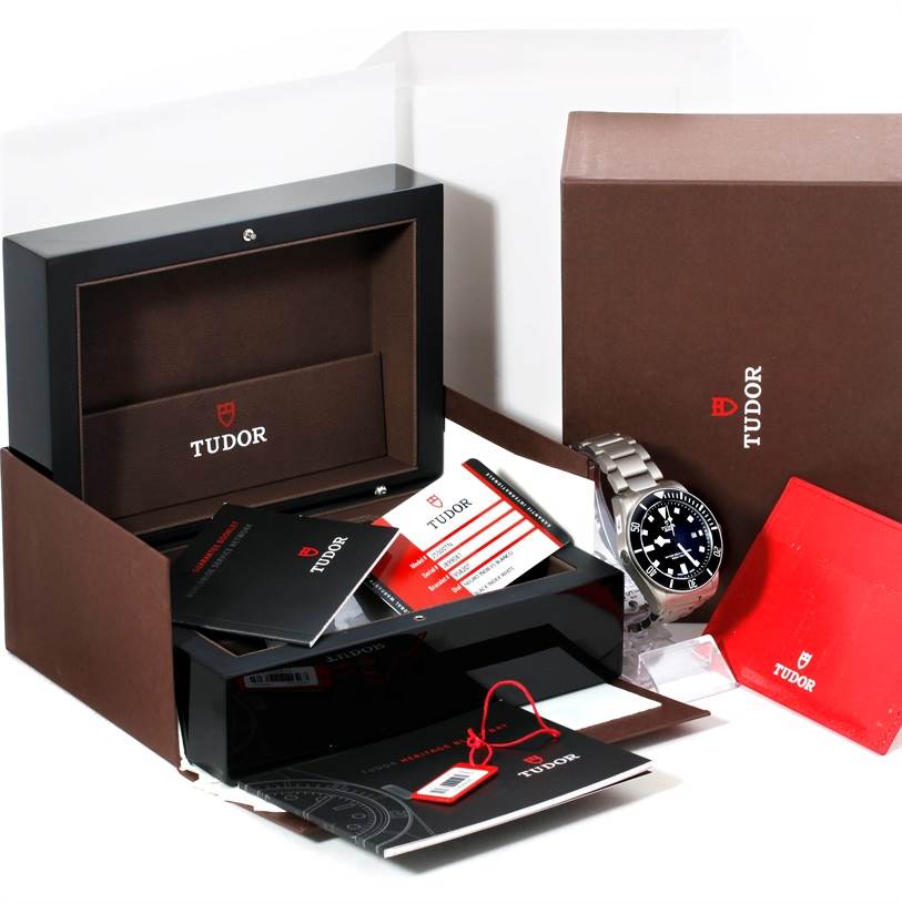 The image shows a Tudor Pelagos 25500TN Men's Titanium Black Dial 25500TN Men's Titanium Black Dial watch, its box, manuals, warranty cards, and packaging materials from a front angle.