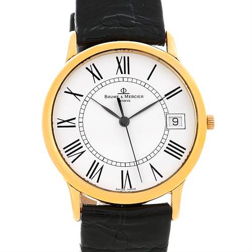 The image shows a front view of the Baume & Mercier Classima MV045077 Men's Yellow Gold White Dial MV045077 Men's Yellow Gold White Dial watch, highlighting its face, Roman numerals, date window, and black leather strap.