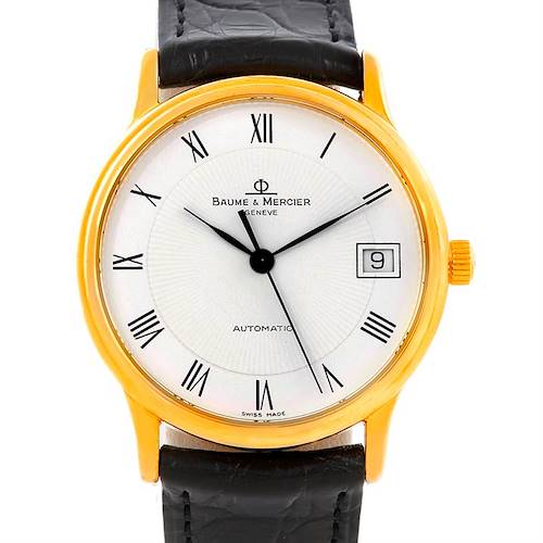 The image shows a front view of the Classima by Baume & Mercier, featuring the dial, case, hands, date window, and leather strap.