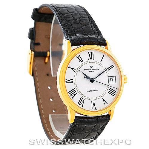 The image shows a Baume & Mercier Classima MV045075 Men's Yellow Gold White Dial MV045075 Men's Yellow Gold White Dial watch at a 3/4 angle, displaying the face, strap, and buckle.