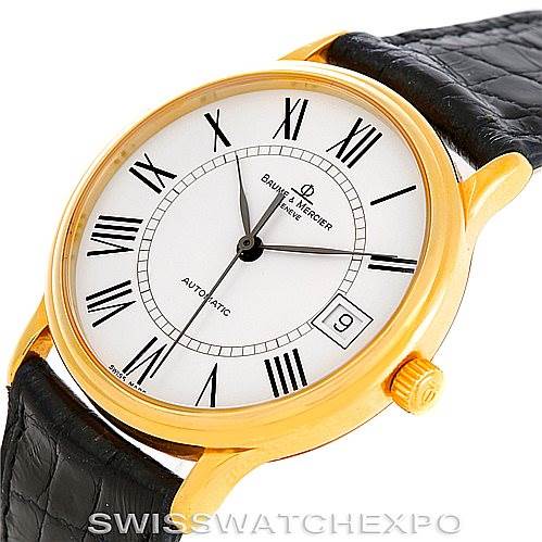 This image shows a close-up of the dial, crown, and leather strap of the Baume & Mercier Classima MV045075 Men's Yellow Gold White Dial MV045075 Men's Yellow Gold White Dial watch.
