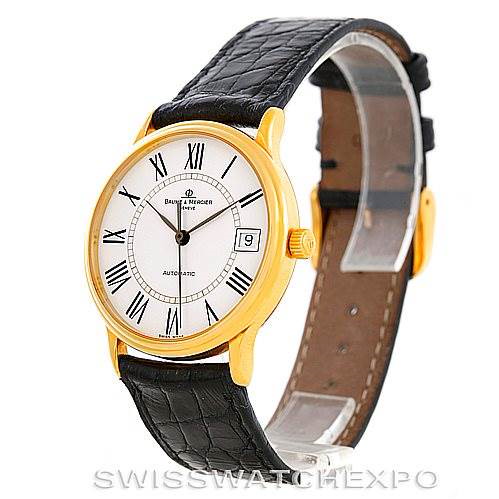This image shows a Baume & Mercier Classima MV045075 Men's Yellow Gold White Dial MV045075 Men's Yellow Gold White Dial watch from an angle that highlights the face, bezel, crown, and leather strap.