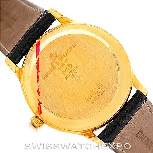 This image shows the back case and leather straps of a Baume & Mercier Classima MV045075 Men's Yellow Gold White Dial MV045075 Men's Yellow Gold White Dial watch from a top-down angle.