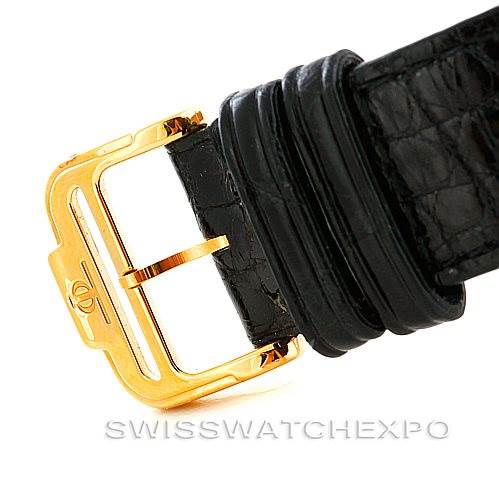 The image shows a close-up of a black leather strap and gold-tone buckle for the Classima model by Baume & Mercier.