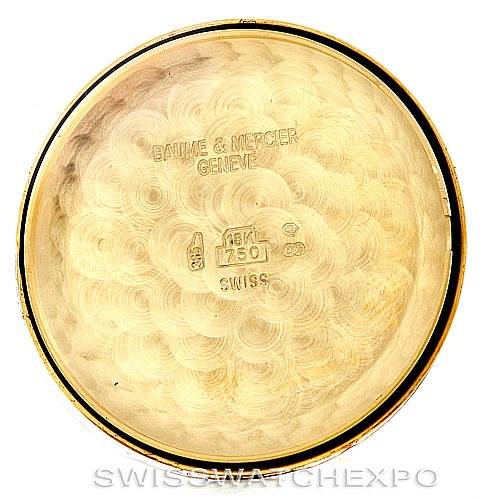 This image shows the inner case back of a Baume & Mercier Classima MV045075 Men's Yellow Gold White Dial MV045075 Men's Yellow Gold White Dial watch, displaying engraved inscriptions and hallmarks.