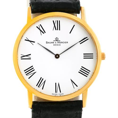 The image shows a front view of a Baume & Mercier Classima MV045088 Men's Yellow Gold White Dial MV045088 Men's Yellow Gold White Dial watch, highlighting its white dial, black Roman numerals, and gold case.