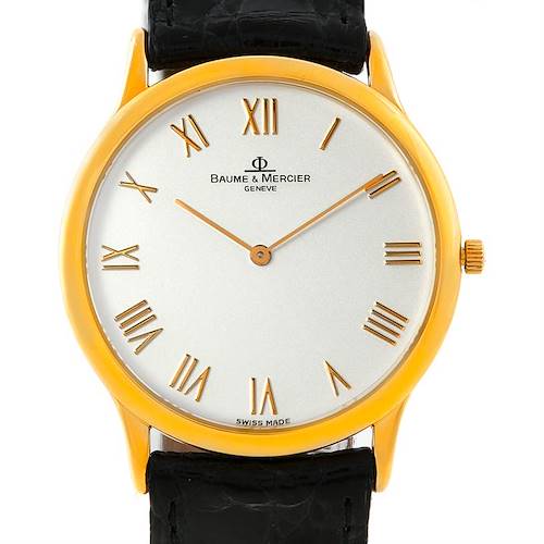 The image shows a frontal view of the Baume & Mercier Classima MV045078 Men's Yellow Gold Silver Dial MV045078 Men's Yellow Gold Silver Dial watch, highlighting its face, Roman numerals, gold-tone case, and black leather strap.