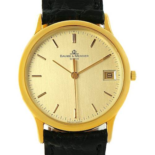 This is a front view of a Baume & Mercier Classima 6149 Men's Yellow Gold Champagne Dial 6149 Men's Yellow Gold Champagne Dial watch, showing the dial, hands, date display, and part of the black strap.