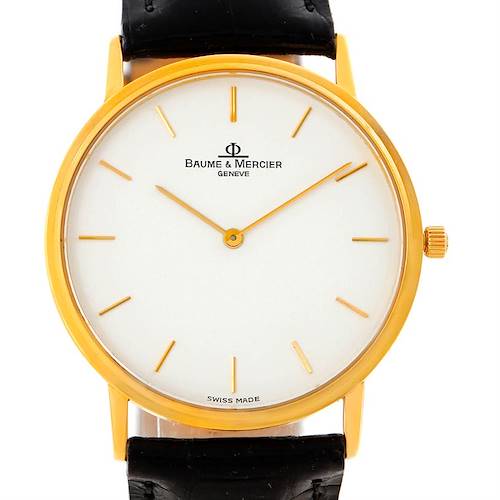 The image shows a front view of the Baume & Mercier Classima MV045088 Men's Yellow Gold White Dial MV045088 Men's Yellow Gold White Dial watch, highlighting the dial, hands, case, and part of the strap.