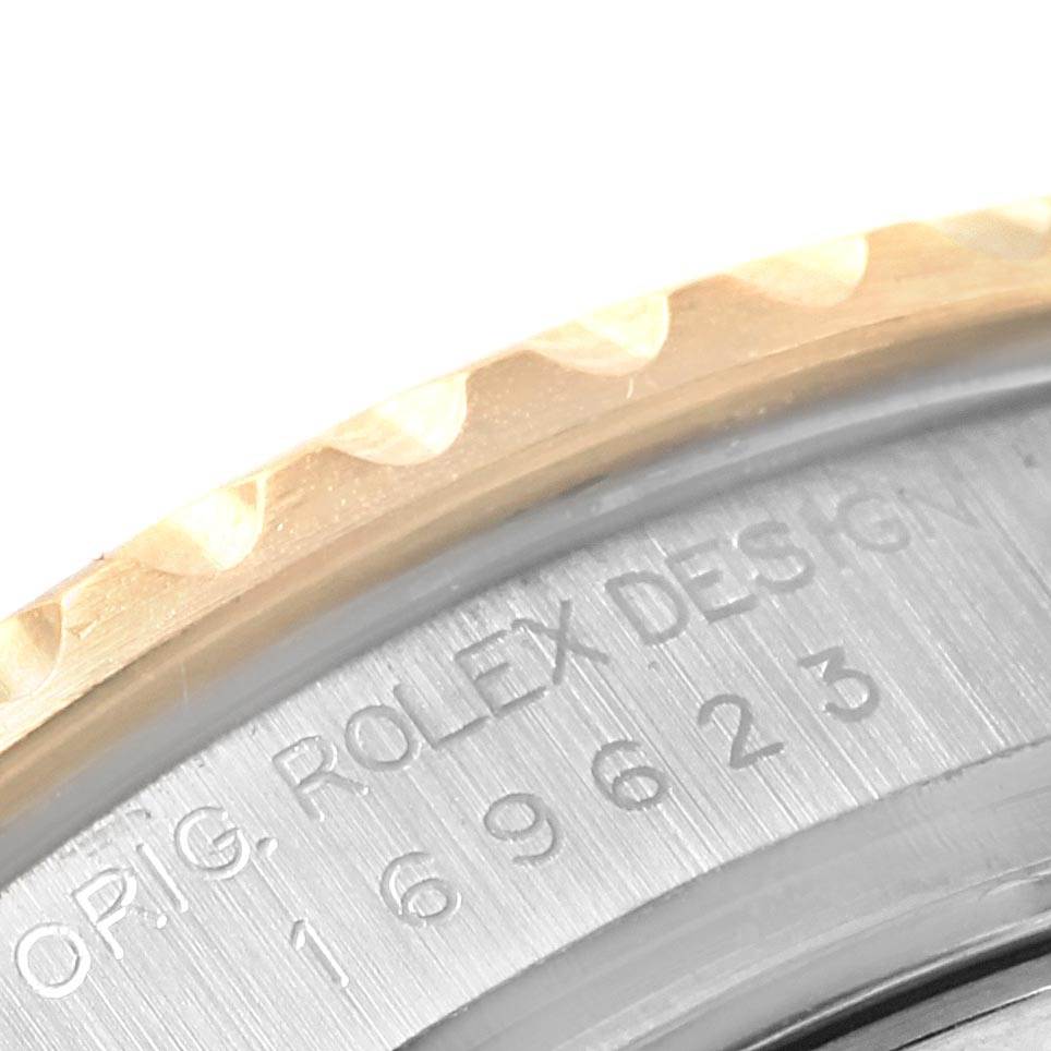 The image shows a close-up of the case back engraving and part of the bezel of a Rolex Yacht-Master 169623 Women's Steel and Gold (two tone) White Dial 169623 Women's Steel and Gold (two tone) White Dial watch.