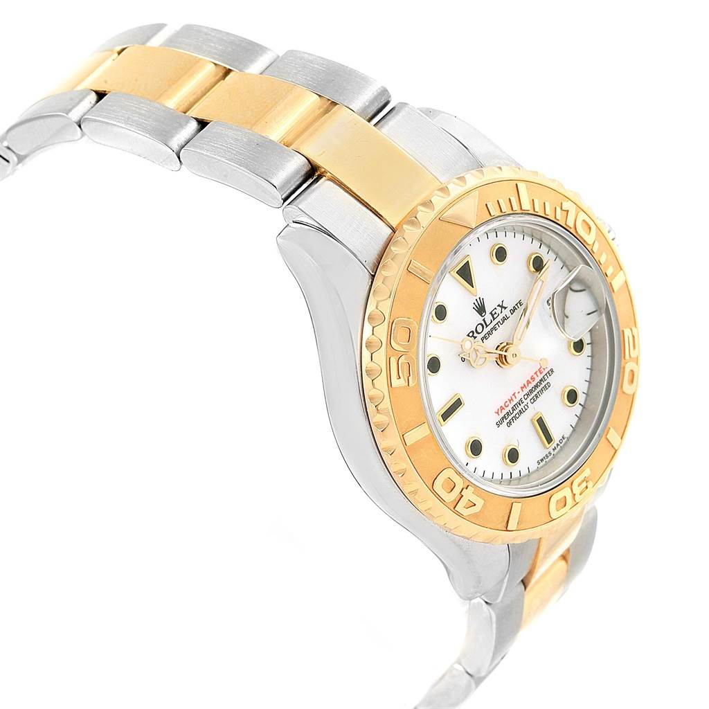 The image showcases a side view of the Rolex Yacht-Master 169623 Women's Steel and Gold (two tone) White Dial 169623 Women's Steel and Gold (two tone) White Dial watch, highlighting its gold and silver bracelet and bezel.