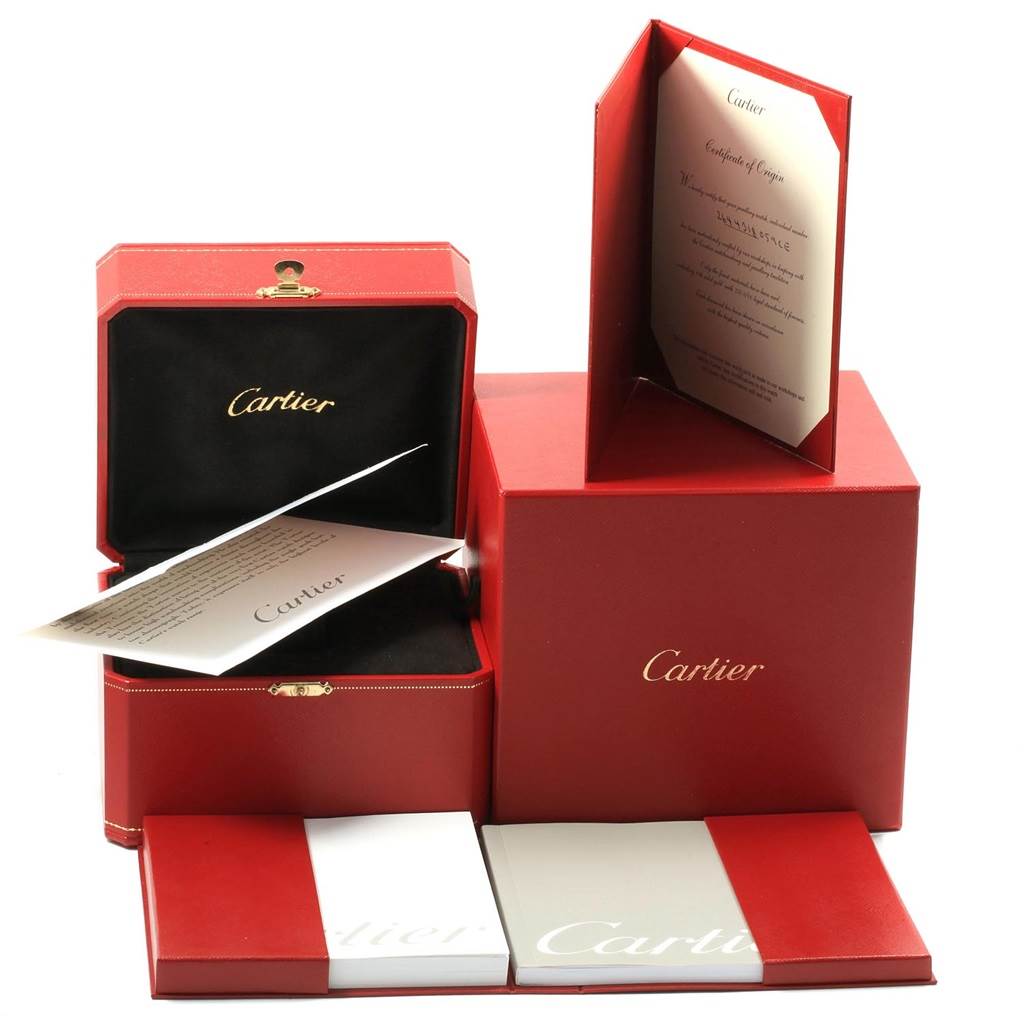 The image shows the packaging and documentation for the Tortue model by Cartier, including a presentation box and certificate.