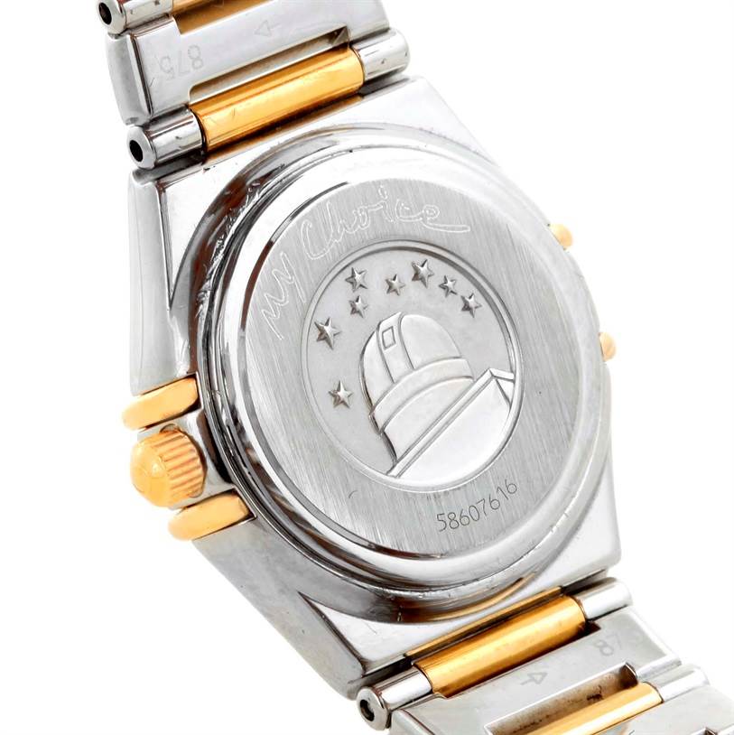 The image shows the back case and part of the bracelet of the Omega 1365.75.00 Women's Steel and Gold (two tone) Mother of Pearl Dial 1365.75.00 Women's Steel and Gold (two tone) Mother of Pearl Dial Constellation Mini Steel Yellow Gold Diamond Watch 1365.75.00.