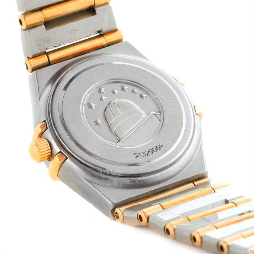 The image shows the back of an Omega 1267.75.00 Women's Steel and Gold (two tone) Mother of Pearl Dial 1267.75.00 Women's Steel and Gold (two tone) Mother of Pearl Dial Constellation My Choice Mini Steel Gold Diamond Watch 1267.75.00, including parts of the bracelet and crown.