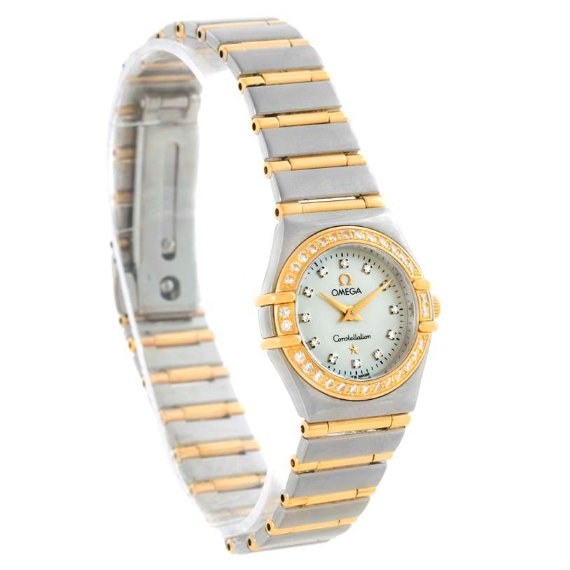 The image shows an Omega 1267.75.00 Women's Steel and Gold (two tone) Mother of Pearl Dial 1267.75.00 Women's Steel and Gold (two tone) Mother of Pearl Dial Constellation My Choice Mini 1267.75.00 watch from a side angle, displaying its face, bracelet, and diamond bezel.