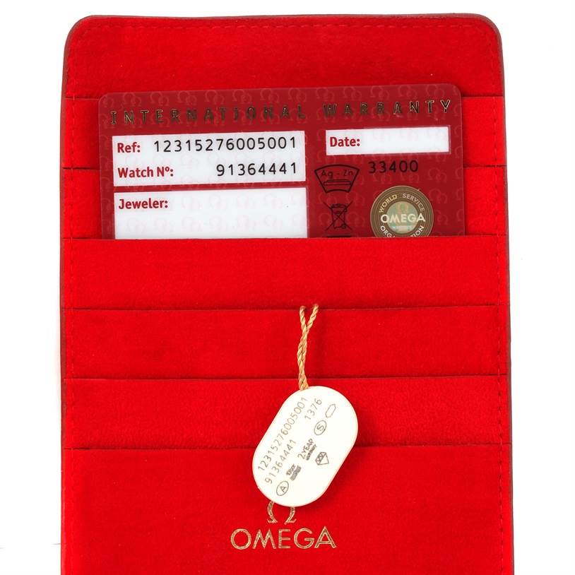 The image shows the warranty card and tag for the Omega 123.15.27.60.05.001 Women's Stainless Steel Mother of Pearl Dial 123.15.27.60.05.001 Women's Stainless Steel Mother of Pearl Dial Constellation 27mm Diamond Ladies Watch, model 123.15.27.60.05.001, in a red holder.