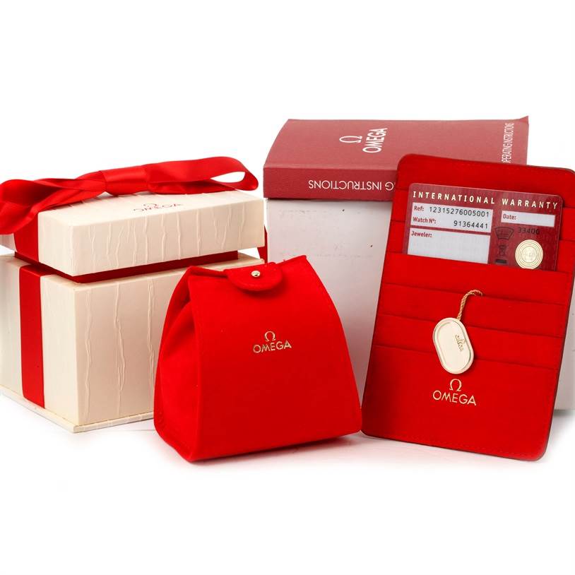 The image shows the packaging and accessories for the Omega 123.15.27.60.05.001 Women's Stainless Steel Mother of Pearl Dial 123.15.27.60.05.001 Women's Stainless Steel Mother of Pearl Dial Constellation 27mm Diamond Ladies Watch model 123.15.27.60.05.001.