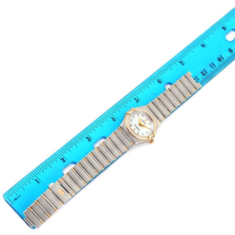 The Omega 1376.75.00 Women's Steel and Gold (two tone) Mother of Pearl Dial 1376.75.00 Women's Steel and Gold (two tone) Mother of Pearl Dial Constellation My Choice Steel Yellow Gold Diamond Watch 1376.75.00 is shown flat against a blue ruler, displaying its full band and face.