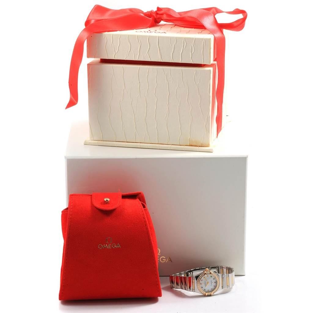 The image shows an Omega 1365.79.00 Women's Steel and Gold (two tone) Mother of Pearl Dial 1365.79.00 Women's Steel and Gold (two tone) Mother of Pearl Dial Constellation Iris Steel Yellow Gold Multi Stone Watch 1365.79.00 with packaging, including a red pouch and gift box.