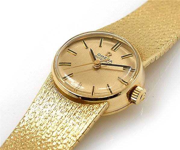 This shows a close-up of the face and part of the band for the Vintage Ladies 18k Yellow Gold Omega 7169 Women's Yellow Gold Champagne Dial 7169 Women's Yellow Gold Champagne Dial 7169 watch.