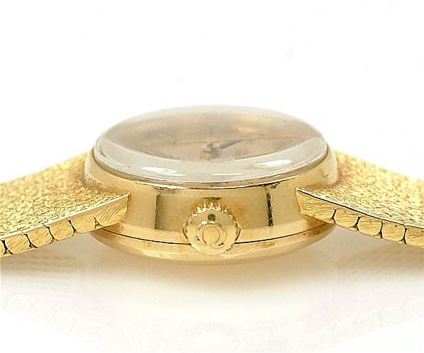 This image shows a side view of the Omega 7169 Women's Yellow Gold Champagne Dial 7169 Women's Yellow Gold Champagne Dial Vintage Ladies 18k Yellow Gold 7169 Watch, focusing on the case and crown.