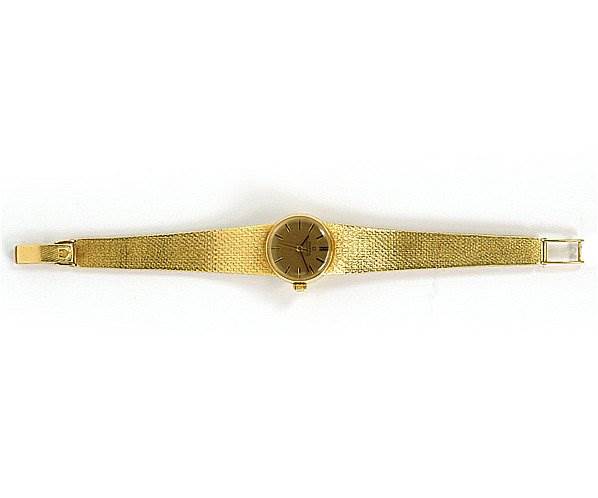 The image shows a top-down view of the Omega 7169 Women's Yellow Gold Champagne Dial 7169 Women's Yellow Gold Champagne Dial Vintage Ladies 18k Yellow Gold 7169 Watch, displaying the entire watch including the face and band.