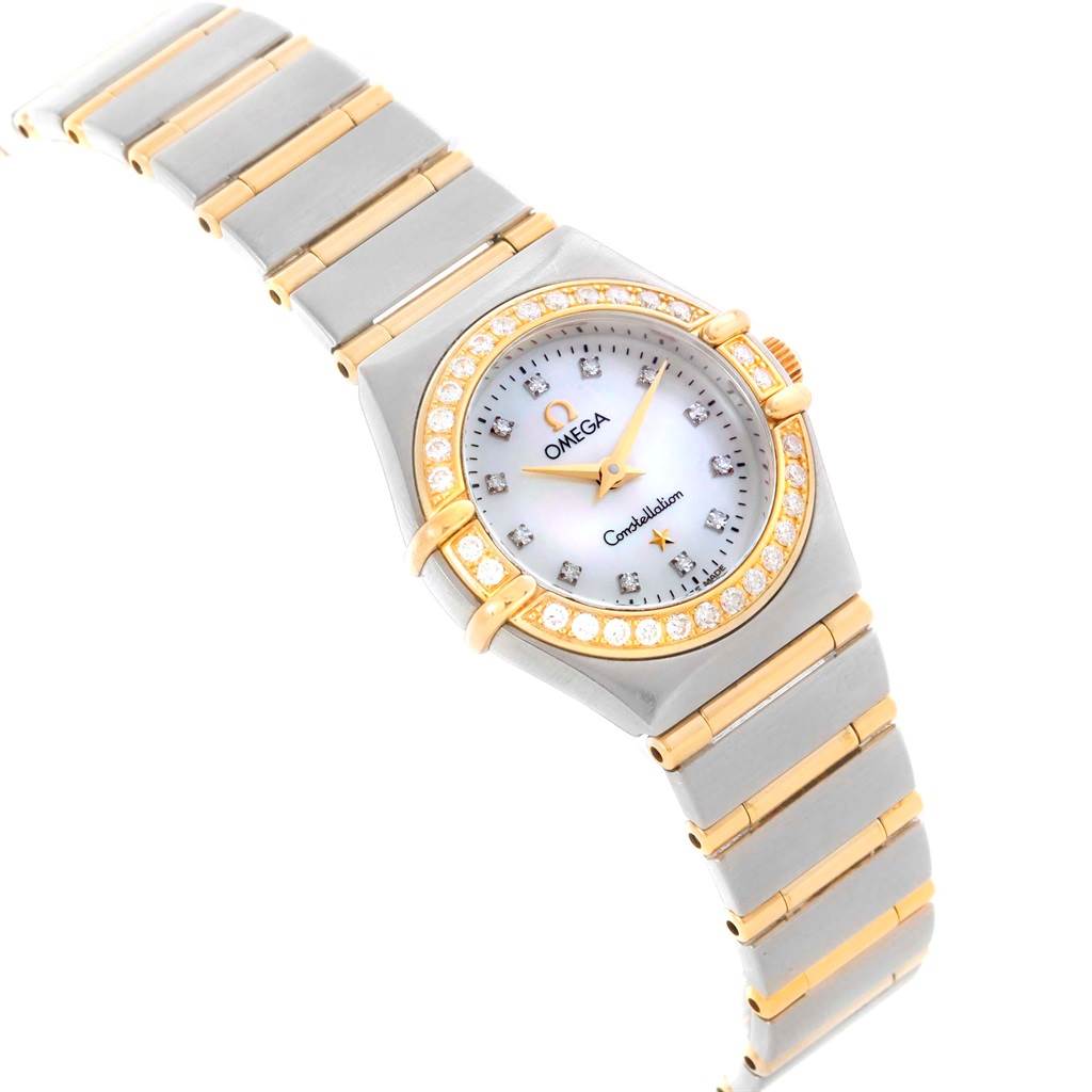 This Omega 1267.75.00 Women's Steel and Gold (two tone) Mother of Pearl Dial 1267.75.00 Women's Steel and Gold (two tone) Mother of Pearl Dial Constellation Mini Mother of Pearl Diamond Watch 1267.75.00 is shown at an angled view highlighting the face, bezel, and bracelet.