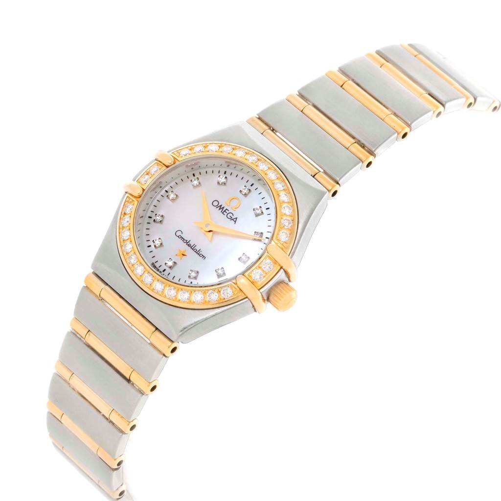 The Omega 1267.75.00 Women's Steel and Gold (two tone) Mother of Pearl Dial 1267.75.00 Women's Steel and Gold (two tone) Mother of Pearl Dial Constellation Mini 1267.75.00 watch is shown at a three-quarter angle, highlighting its mother-of-pearl dial and diamond bezel.
