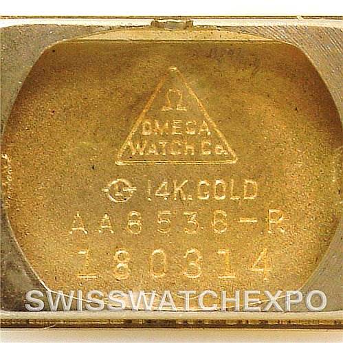 This image shows the inner case back of the Omega Women's Yellow Gold Silver Dial Women's Yellow Gold Silver Dial Vintage Ladies 14k Yellow Gold Watch Made For Tiffany, highlighting the gold markings and model numbers.